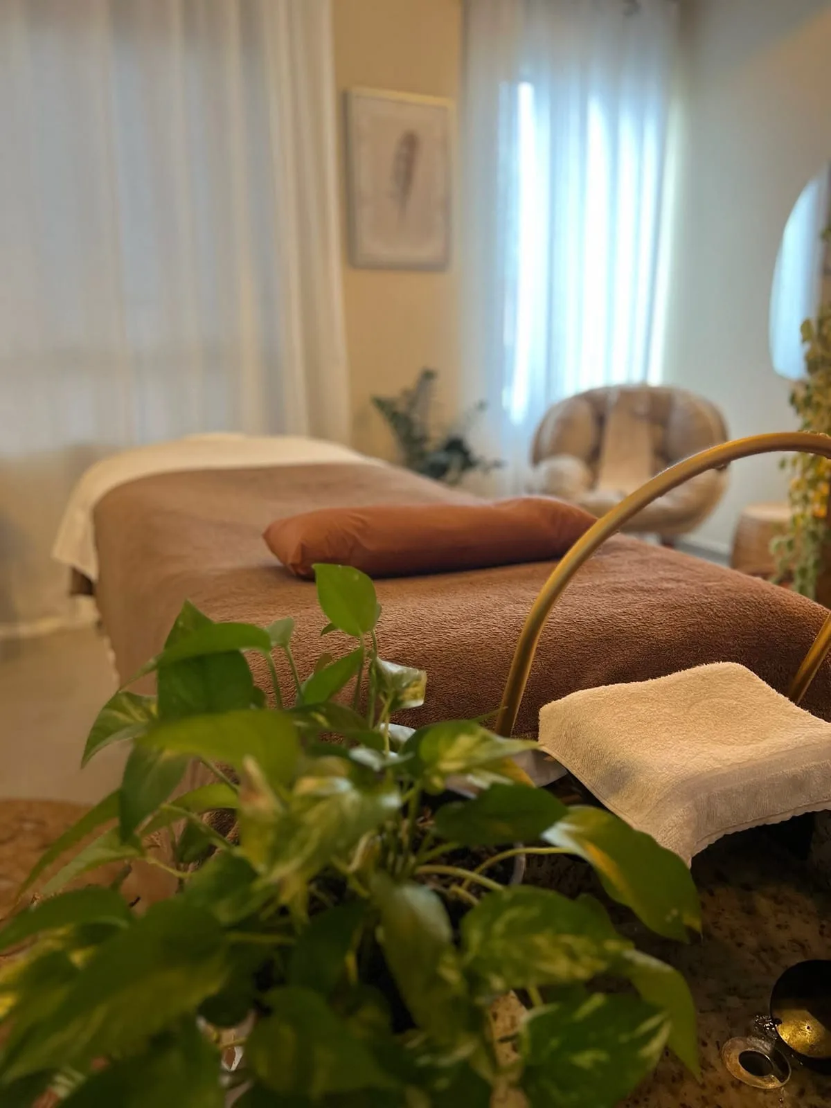 Sala de atendimento do Etti Spa com maca, cortinas claras e plantas